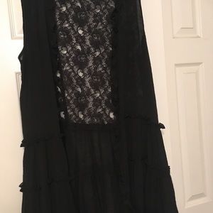 Black ruffled vest with lace on the back